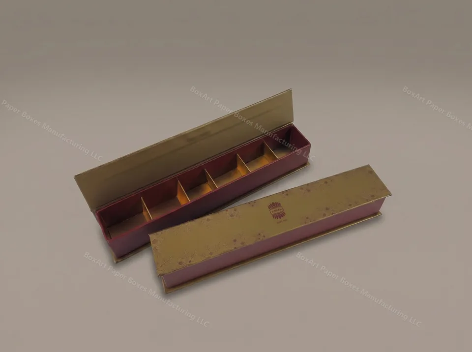 Ajmal Hinged Chocolate Box — luxury chocolate boxes manufactured in Dubai by BOXART — Slim hinged-lid box with gold lid, burgundy tray and five compartments — botanical foil print for Ajmal.