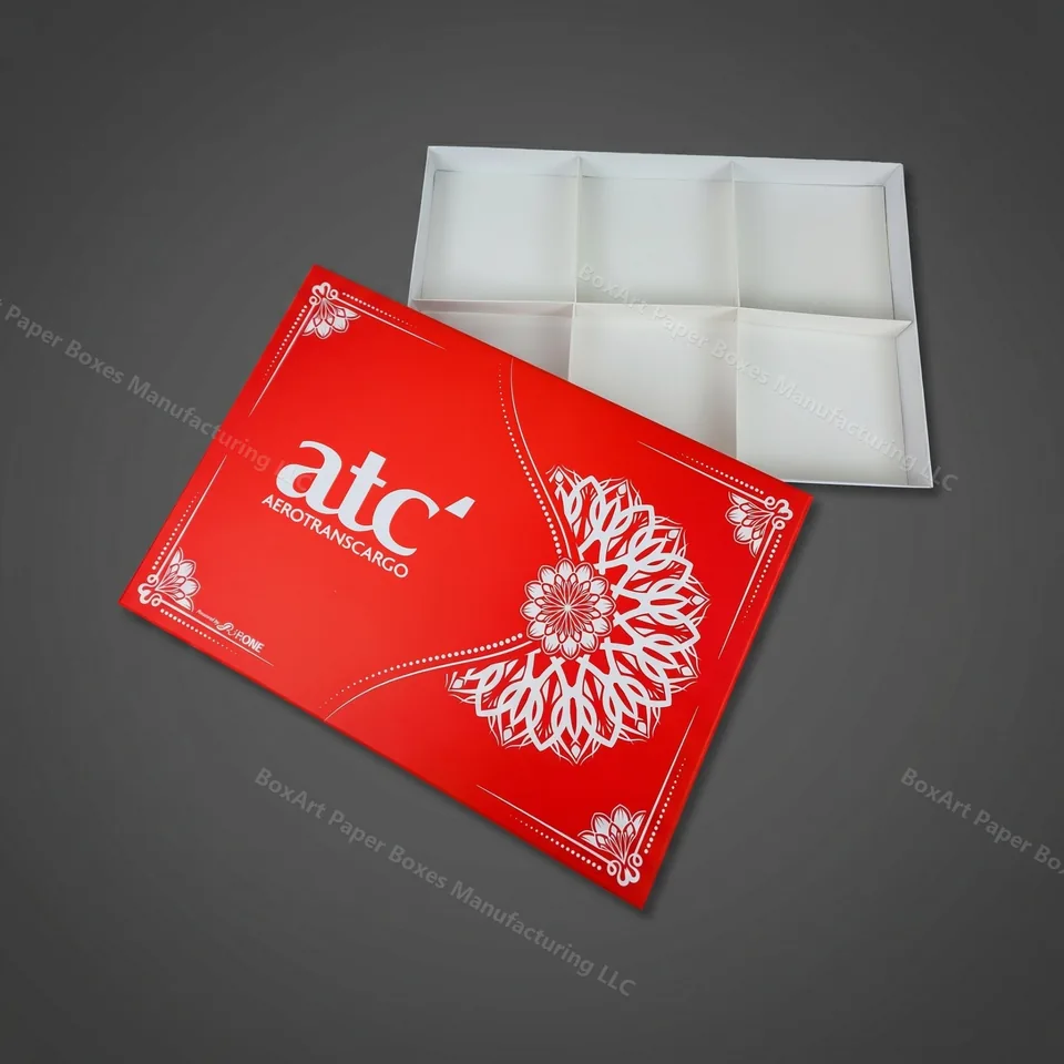 ATC Two-Piece Rigid Gift Box — luxury rigid boxes manufactured in Dubai by BOXART — Two-piece rigid gift box with six-compartment insert tray, red exterior and clean white interior.