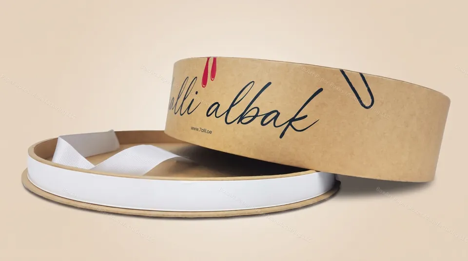 7alli Albak — luxury kraft boxes manufactured in Dubai by BOXART — Round kraft gift box with ribbon