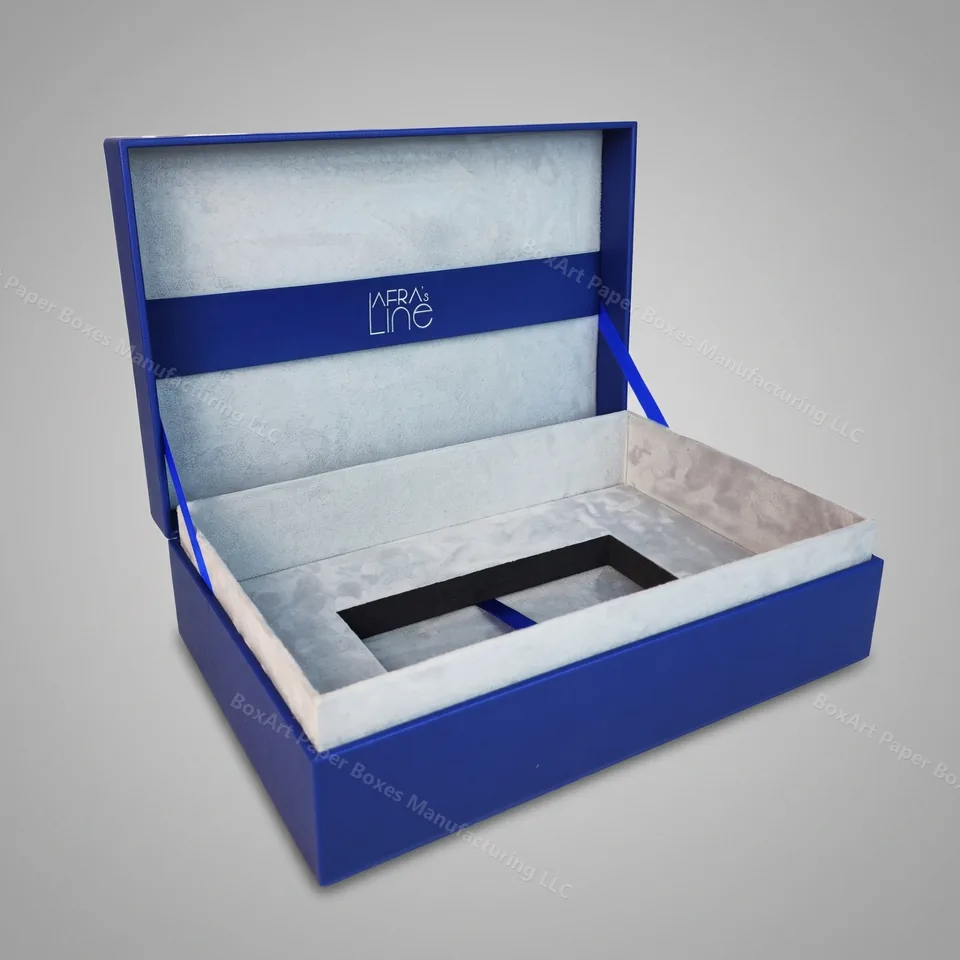 Afra's Line Hinged Jewelry Box — luxury jewelry boxes manufactured in Dubai by BOXART — Hinged-lid rigid box wrapped in cobalt-blue leatherette with soft grey suede interior and silver hot-stamp logo.